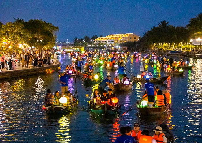 Delicate lanterns bob gently on the Thu Bon River